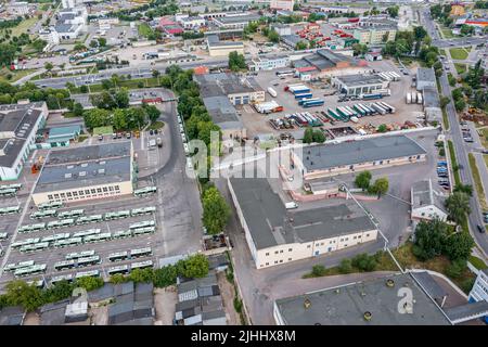 zone industrielle urbaine. dépôt d'autobus avec garage de stationnement et autobus garés. vue aérienne au-dessus. Banque D'Images