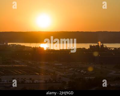 Une vue aérienne vers le coucher du soleil sur une grande zone industrielle de fabrication. Banque D'Images