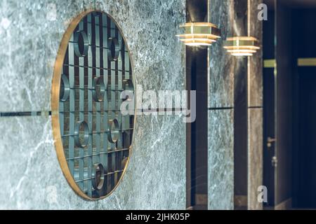 Intérieur moderne de l'entrée dans un bâtiment résidentiel de luxe. Miroir sur mur. Grille en fer forgé. Banque D'Images