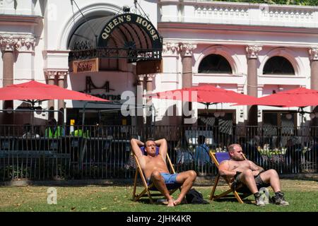 Les gens sont assis au soleil à Leicester Square, dans le centre de Londres, alors que les Britanniques sont sur le point de connaître la journée britannique la plus chaude jamais enregistrée, alors que les températures devraient atteindre 40C. Date de la photo: Mardi 19 juillet 2022. Banque D'Images