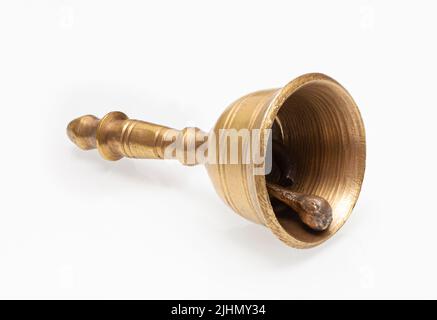 Petite cloche en bronze antique isolée sur fond blanc. Avec masque Banque D'Images