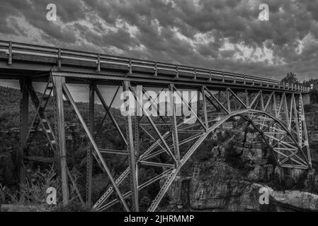 Une photo en niveaux de gris du pont Midgley sous un ciel très nuageux Banque D'Images