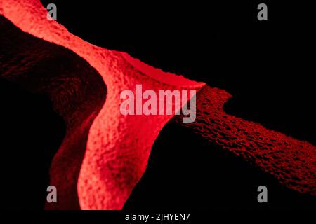 Texture de la lueur rouge et roches dans les fissures Banque D'Images