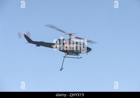 L'hélicoptère H303 du Département des forêts de la Californie fait le tour de la zone de chute avant de faire une goutte d'eau sur un feu de broussailles Banque D'Images