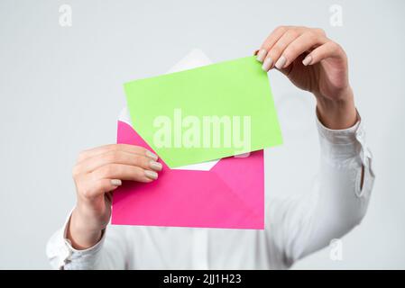 Mains de la femme professionnelle lettre de mise avec message crucial dans l'enveloppe. Femme d'affaires ayant un document entre les mains envoyant des informations importantes Banque D'Images