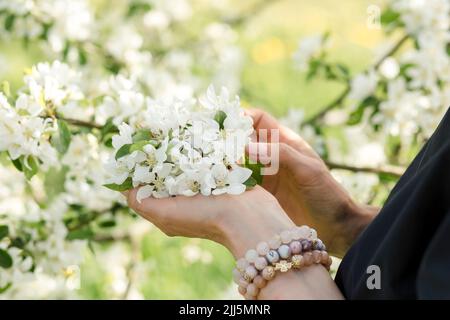 Mains de femme tenant des fleurs blanches Banque D'Images