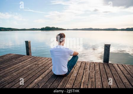 Homme regardant la vue panoramique depuis la jetée sur le lac Banque D'Images
