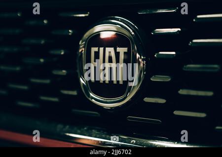 Magnifique tipo de fiat rouge garée dans un garage sombre avec des lumières avant et arrière éblouissantes. Banque D'Images