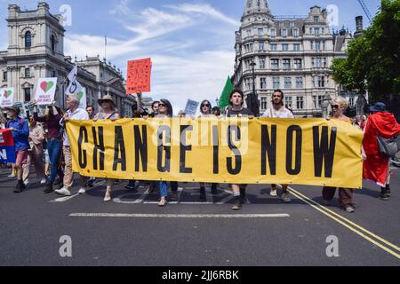 Londres, Royaume-Uni. 23rd juillet 2022. Les manifestants tiennent une bannière « change is now » pendant la manifestation sur la place du Parlement. Les manifestants de Just Stop Oil, la rébellion contre l'extinction, isolent la Grande-Bretagne et d'autres groupes ont défilé dans le centre de Londres en appelant le gouvernement à mettre fin aux combustibles fossiles, à taxer les grands pollueurs et les milliardaires, à fournir une isolation à tous les foyers et à agir sur la crise du climat et du coût de la vie. Crédit : SOPA Images Limited/Alamy Live News Banque D'Images