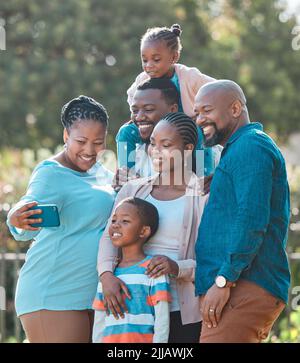 Gran a toujours la famille entière comme son image de profil. Une famille multi-générationnelle prenant un selfie ensemble. Banque D'Images