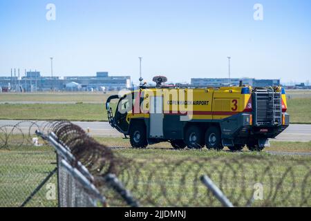 Copenhague / DANEMARK - 22 JUILLET 2022 : un véhicule de secours d'incendie à l'aéroport de Copenhague CPH, en conduisant sur la voie de circulation. Banque D'Images