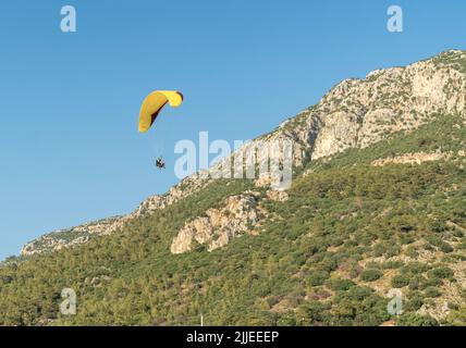 Fethiye, Muğla / Turquie - 07.04.2022: Parapente des gens près de la montagne Babadadag à Oludeniz. Banque D'Images