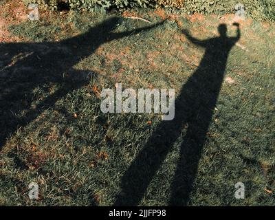 Ombres d'un couple charmant sous la lumière du soleil en été. Banque D'Images