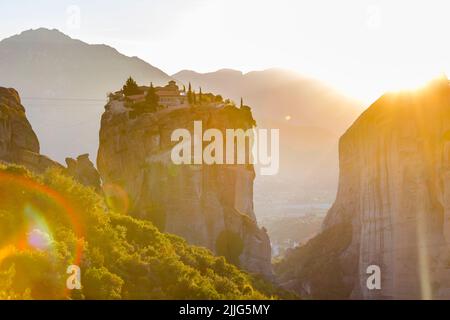 Le monastère grec miraculeux dans une lumière du soleil sur la formation rocheuse au coucher du soleil, Meteora, Grèce. Mystérieuse pendaison sur des monastères de rochers près de Kal Banque D'Images