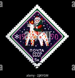 Santa Claus aka Père Frost avec un arbre de pin sur le cheval de conte de fées pour le nouvel an, vers 1989. Bonne année 1990 comme texte. Vintage post timbre isolé Banque D'Images