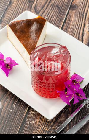 Thé aux fraises et cheesecake de san sebastian sur une table en bois Banque D'Images