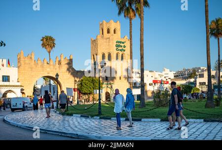 Les touristes et les visteurs marchent vers une porte d'entrée de la marina à Port El Kantaoui en Tunisie. Banque D'Images