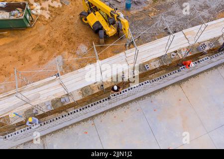 Dans un chantier de construction échafaudage où des blocs de maçonnerie sont posés sur des blocs de béton de cinder mis en place Banque D'Images