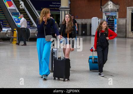 Londres, Royaume-Uni. 27th juillet 2022. Les passagers avec des valises arrivent à la gare Victoria de Londres pendant la grève nationale des chemins de fer. Les membres des syndicats du Syndicat national des travailleurs du rail, des transports maritimes (RMT), de l'Associated Society of Locomotive Engineers and Firemen (ASLEF) et de l'Association du personnel des transports salariés (TSSA) sont en grève sur les négociations salariales, ce qui entraîne une réduction et une annulation des services ferroviaires dans tout le Royaume-Uni. (Photo par Steve Taylor/SOPA Images/Sipa USA) crédit: SIPA USA/Alay Live News Banque D'Images