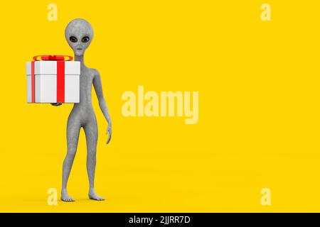 Personnage de cartoon Alien humanoïde gris effrayant Mascot et boîte cadeau avec ruban rouge sur fond jaune. 3D rendu Banque D'Images