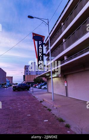 Une photo verticale d'un panneau de stationnement devant le garage privé contre le ciel bleu. Lubbock, Texas. Banque D'Images