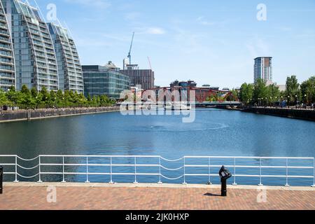 Salford Quays Manchester juillet 2022 en regardant de l'autre côté des quais vers des bâtiments modernes et une zone de baignade à pont tournant en eau claire et fraîche Banque D'Images