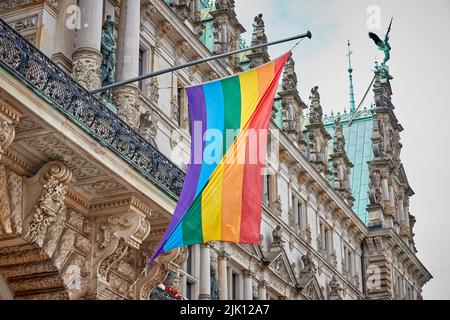 29 juillet 2022, Hambourg : un drapeau arc-en-ciel surplombe l'entrée de l'hôtel de ville de Hambourg. Pour démarrer la semaine de la fierté, le drapeau arc-en-ciel a été levé pendant la campagne « Hambourg montre le drapeau ». Photo: Georg Wendt/dpa Banque D'Images