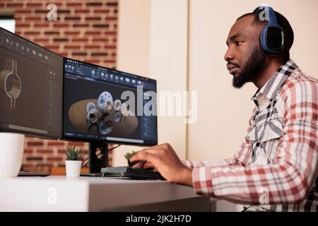 Un ingénieur afro-américain effectue un prototypage de modèles d'engrenages sur des logiciels de fabrication, développant des moteurs pour l'innovation technique de l'industrie. Création de la conception de turbines avec la science de la CAO industrielle. Banque D'Images