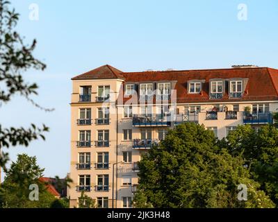 Grand immeuble d'appartements avec beaucoup de balcons sur la façade. Architecture dans la ville pendant la soirée. Une maison au coucher du soleil à Dresde. Banque D'Images