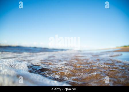 Vague de l'océan bleu doux sur une plage de sable. L'arrière-plan. Banque D'Images