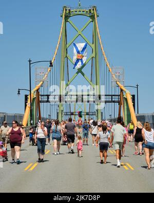 Halifax, Canada. 31 juillet 2022. Au cours d'un bel après-midi ensoleillé, des centaines de personnes prennent leurs chaussures de marche pour prendre le pont Angus MacDonald Memorial Bridge lors de la promenade annuelle du pont. Le pont MacDonald qui relie Halifax à Dartmouth aujourd'hui est libre de voiture pour permettre aux piétons de profiter de la vue sur le port et de marcher d'un côté à l'autre. Credit: Meanderingemu/Alamy Live News Banque D'Images