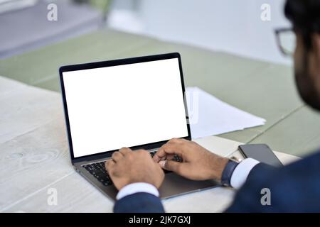 Homme d'affaires portant un costume sur un ordinateur portable avec écran blanc maquette. Banque D'Images