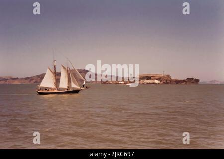 Bateau à voile dans la baie de San Francisco avec l'île d'Alcatraz en arrière-plan. Banque D'Images