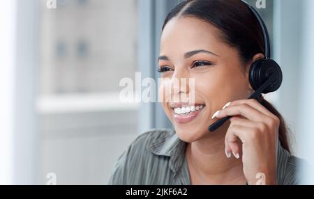 Si heureux d'aider les autres, une jeune femme d'affaires travaillant dans un centre d'appels. Banque D'Images