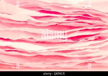 les couches de papier rose empilent un arrière-plan abstrait ondulé Banque D'Images