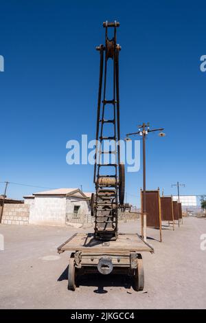 Exposition en plein air d'une ancienne grue de levage sur les voies ferrées utilisées dans les travaux de salpeter à Humberstone, au Chili. Banque D'Images