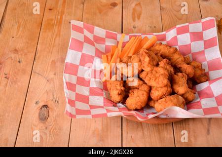 A plate of chicken nuggets on a wooden table Stock Photo