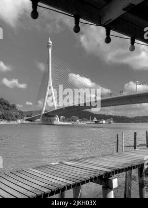 A vertical grayscale of the modern Raja Isteri Pengiran Anak Hajah Saleha Bridge in Brunei Stock Photo