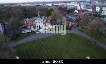 A drone shot of a Warrington town hall and golden gates in Cheshire, UK Stock Photo