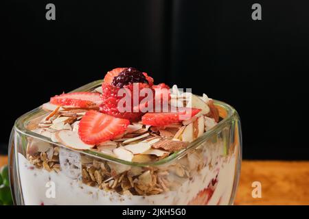 A closeup shot of yogurt with oatmeal and strawberry served in a cup for breakfast Stock Photo