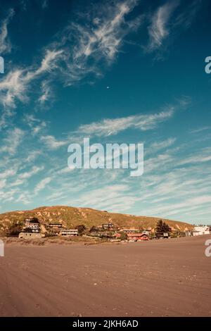 A vertical view of a landscape with buildings underneath a hill in Matanzas, Chile Stock Photo