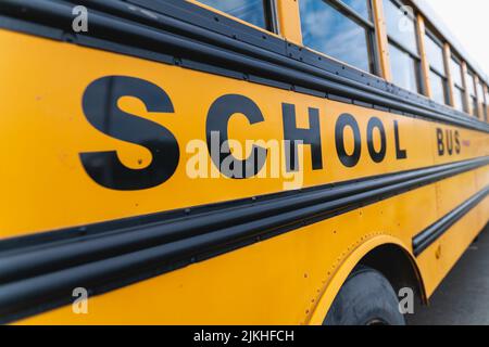 A closeup of yellow classic school bus. Side view. American education. Stock Photo