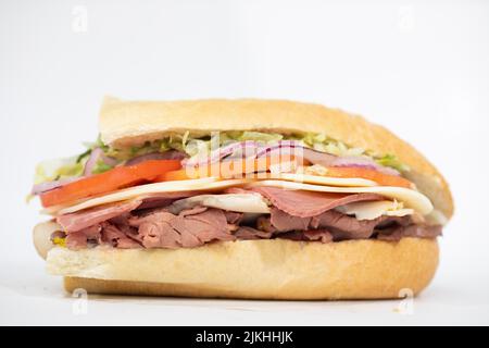 An Italian sub sandwich portraying all of its ingredients on a white background Stock Photo