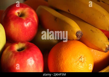 A close up of various seasonal fruits with oranges, bananas and apples Stock Photo