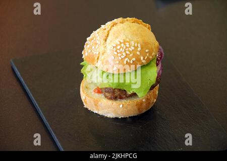 A delicious mini hamburger on a black plate Stock Photo