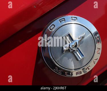 A close-up of the gas cap with logo for a 1966 Ford Mustang at the car show in San Antonio, Texas, United States Stock Photo