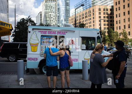 Some people standing next to an ice cream truck in New York City. Stock Photo