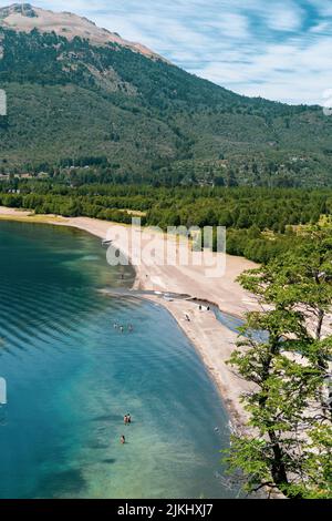 A mesmerizing seascape view surrounded by high dense trees and mountains in the background Stock Photo