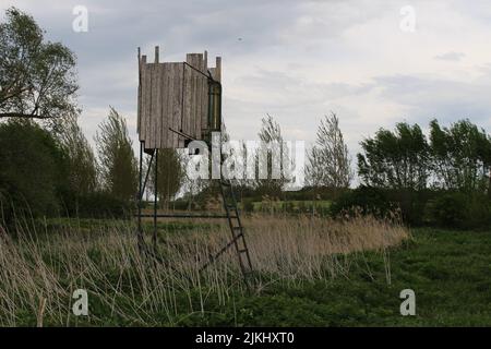 A small wooden hunter's hut, elevated, in the middle of the countryside. Stock Photo