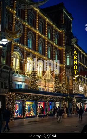 A vertical shot of a beautiful building with Christmas lights, decorations in Dublin, Ireland at night Stock Photo